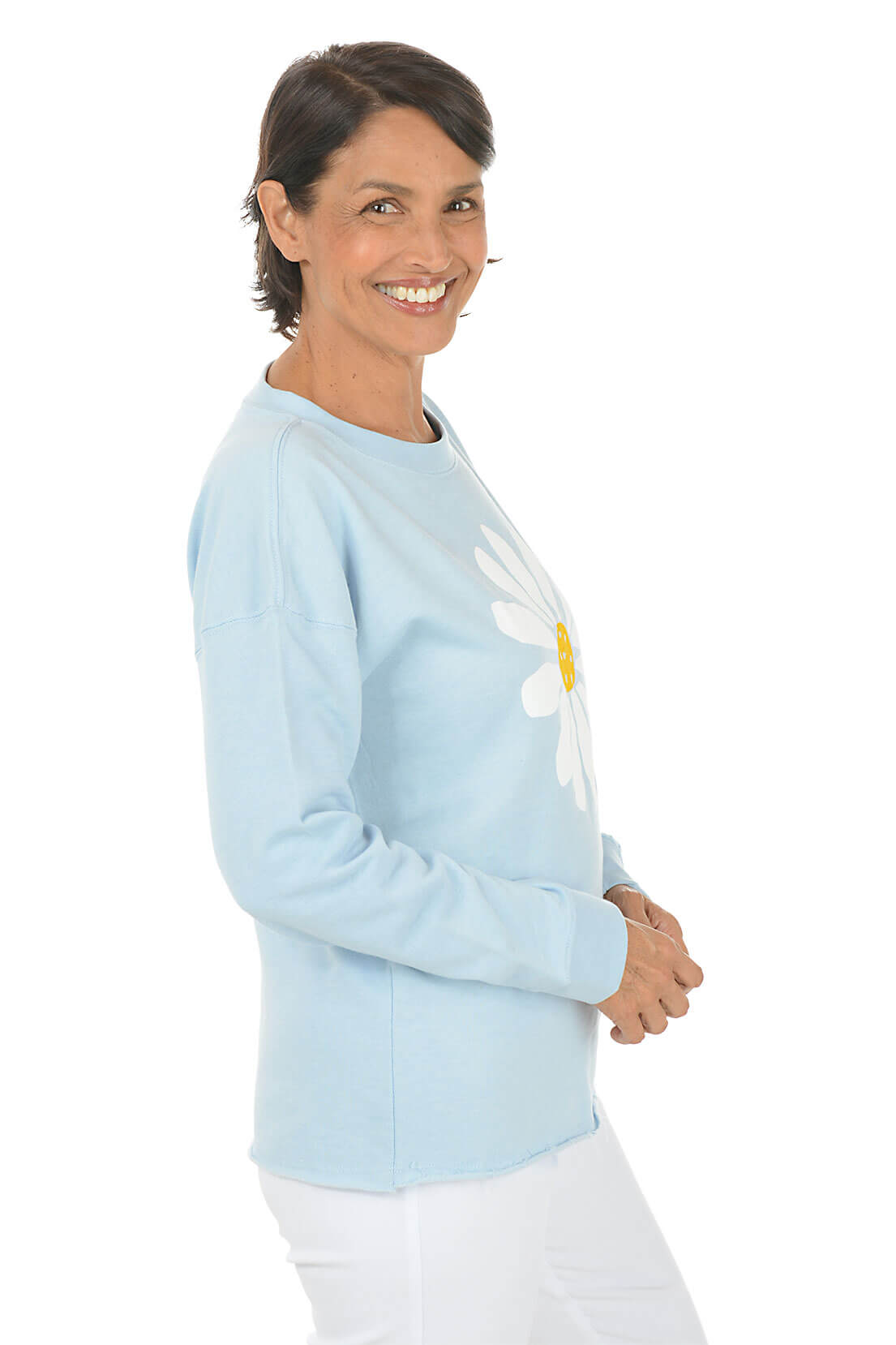 Woman wearing a light blue sweater with a white shirt underneath on a white background