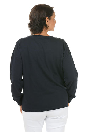 Person wearing a black sweater and white pants on a white background