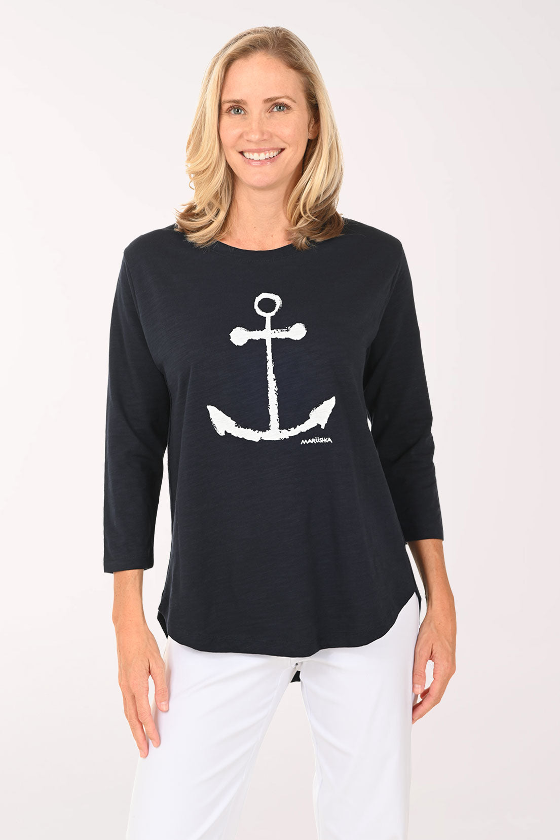 Woman wearing a white and navy 3/4 sleeve top with an anchor