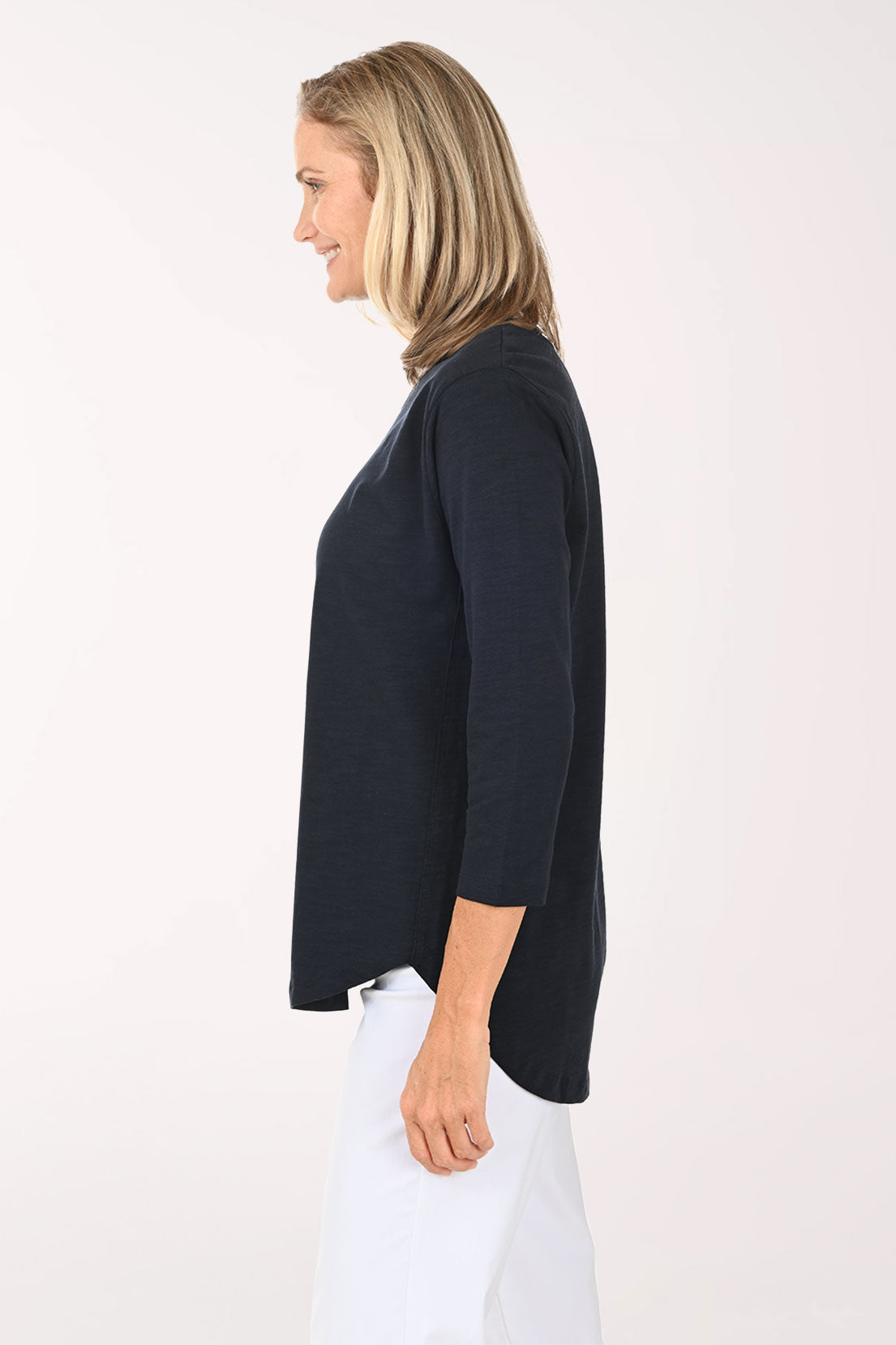 Woman wearing a white and navy 3/4 sleeve top with an anchor