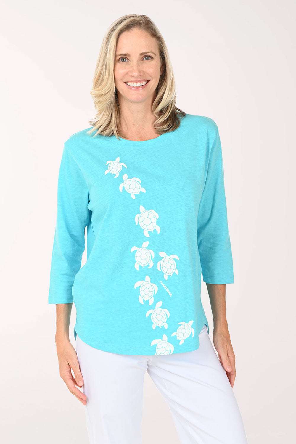 Woman wearing an aqua top with sea turtles