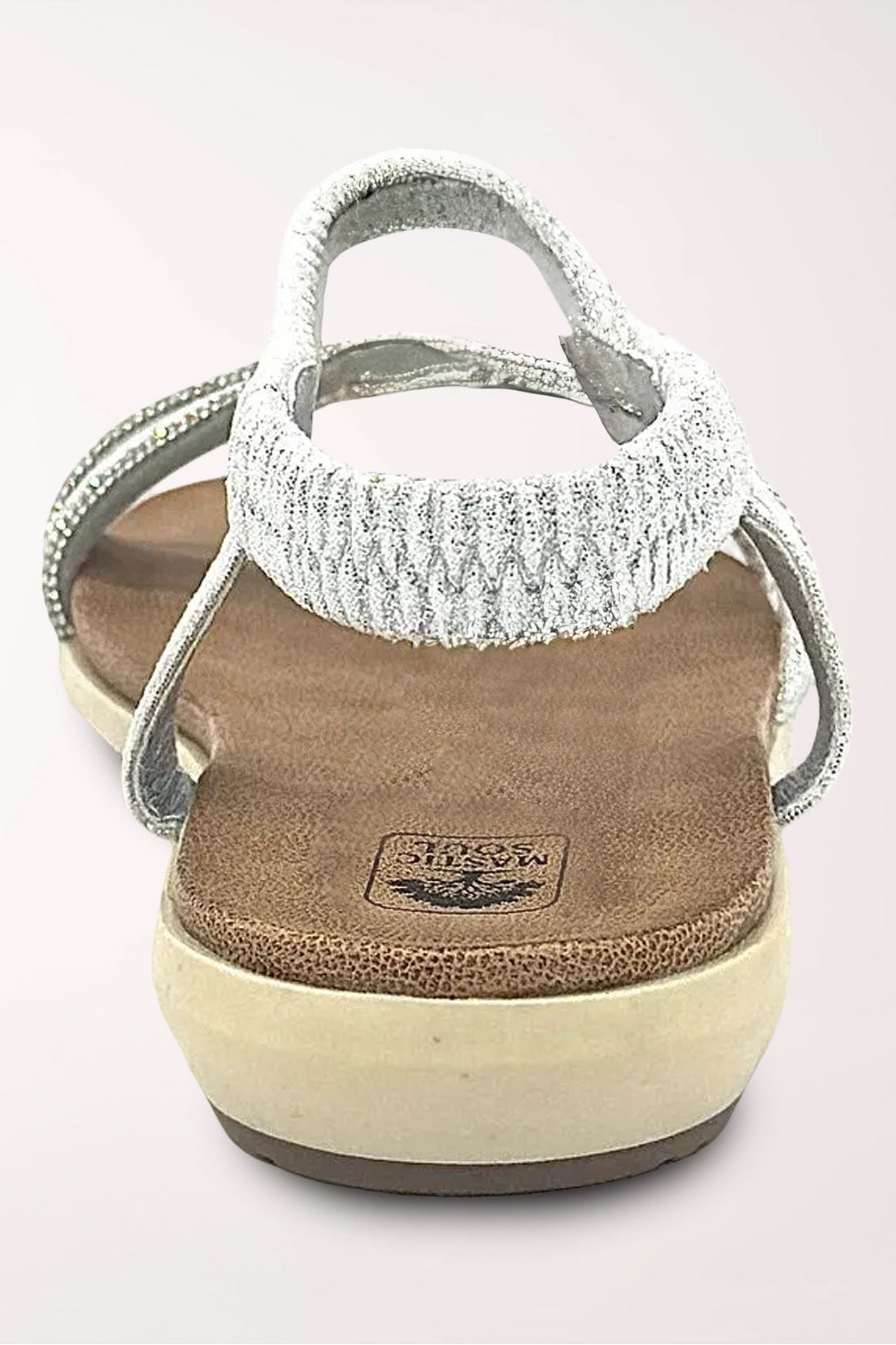 Back view of the silver Alina sandal showing the sparkling elastic slingback strap and cushioned heel.