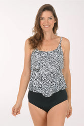 Woman wearing a black and white patterned tank top and black high-waisted bikini bottoms on a white background.