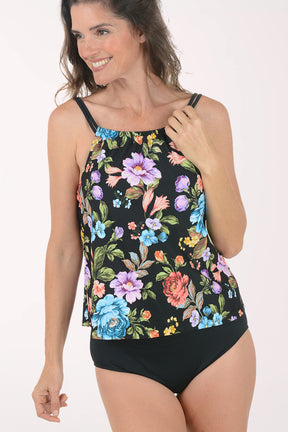 Woman wearing a floral tankini set on a white background. Detail shot.