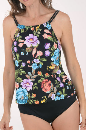 Woman wearing a floral tankini set on a white background. Detail shot.