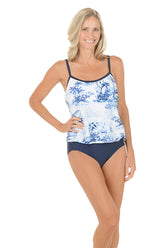 A woman wearing a blue and white one piece swimsuit.