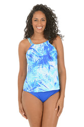 Woman wearing a blue and white patterned tankini top on a white background.