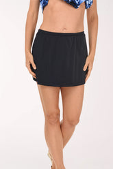 Front view of the Maxine Solid Skirted Swim Bottom in black, a pull-on swim skirt with a gathered stretch waistband, worn with a blue and white printed swim top.