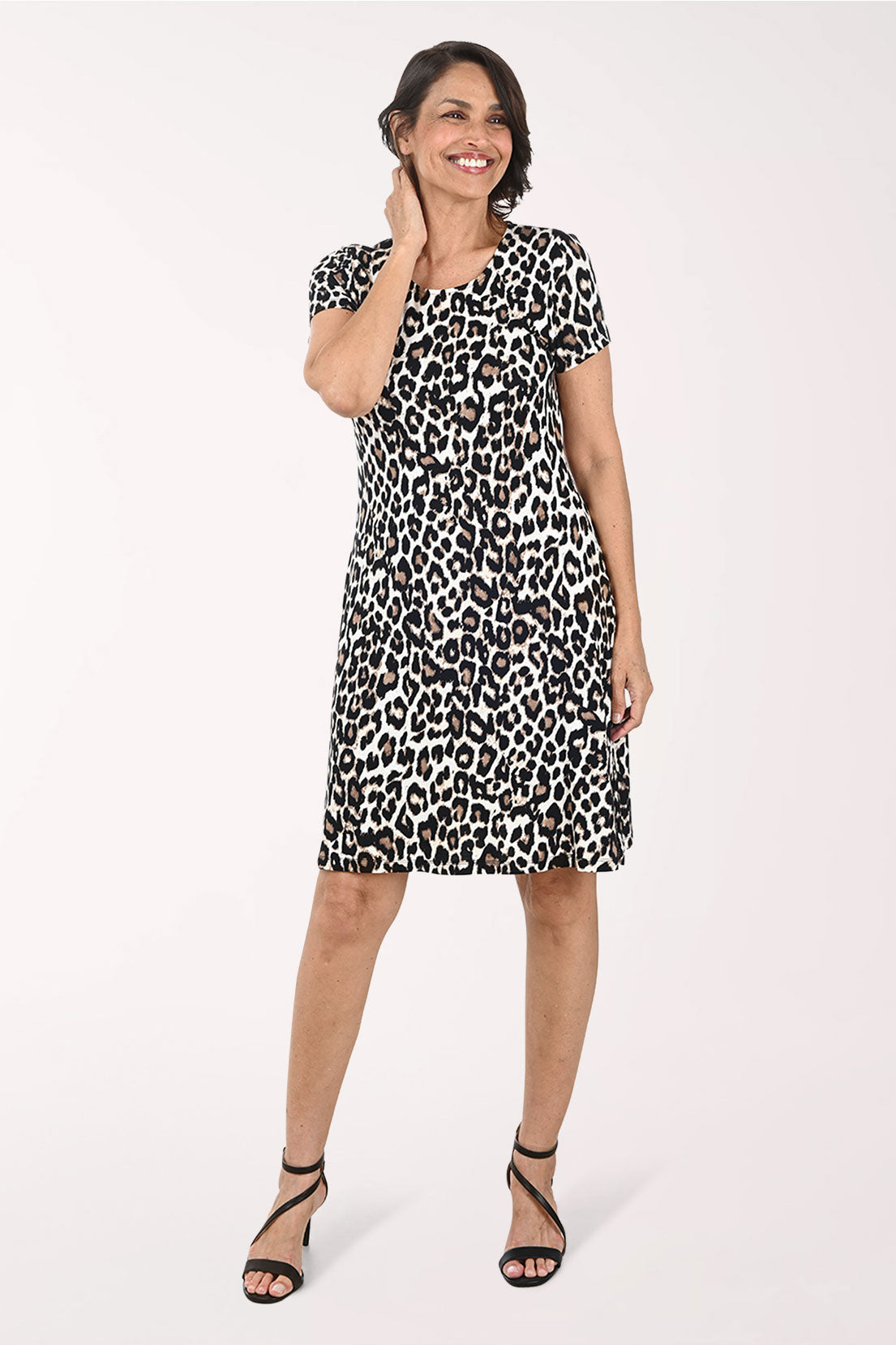 Woman wearing a leopard print dress on a white background