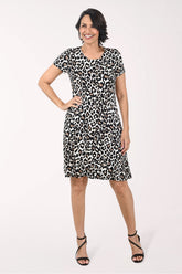 Woman wearing a leopard print dress on a white background