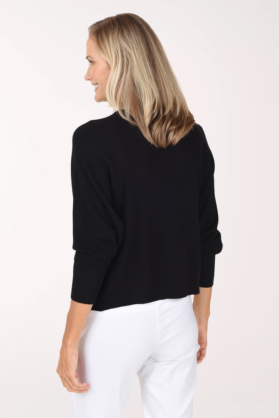 Woman wearing a black 3/4 sleeve solid cardigan 