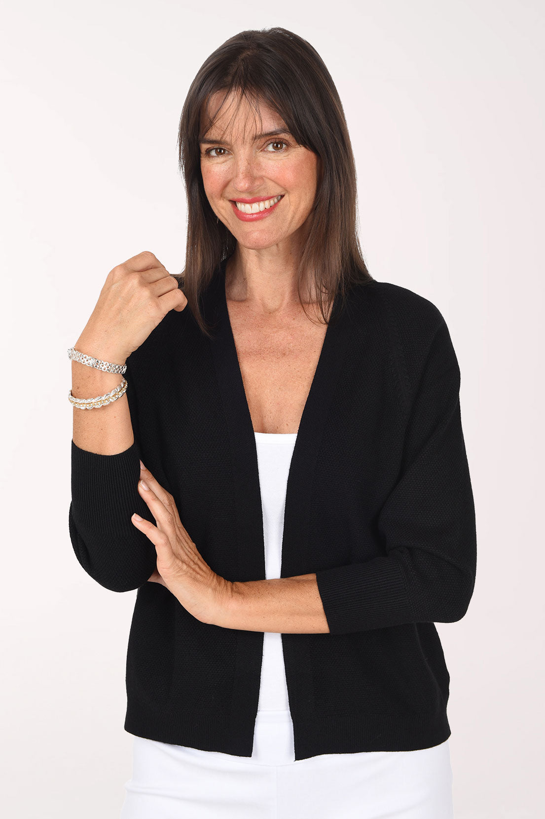 Front view of the black Waffle Knit Open Cardigan showing the open front, ribbed cuffs and cropped length over a white tank.