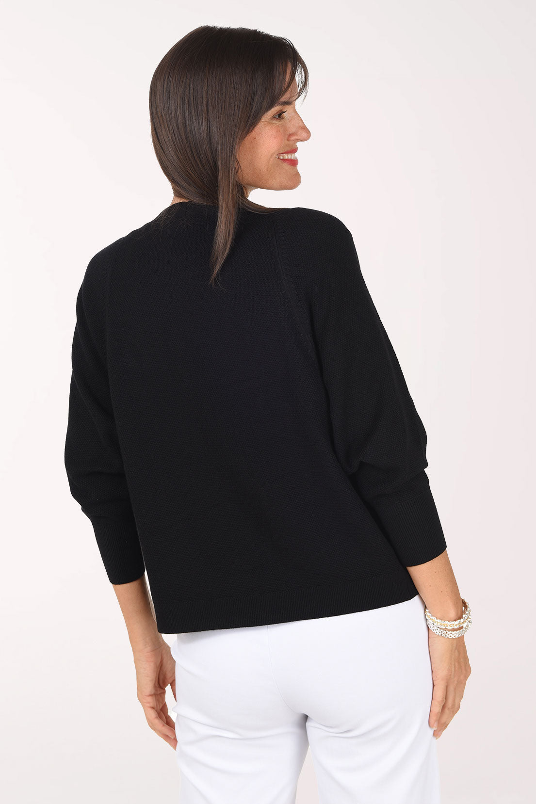 Back view of the black Waffle Knit Open Cardigan showing the relaxed raglan sleeves and ribbed hemline.