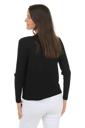 Woman wearing a long sleeve black cardigan sweater over a white top on a white background. Back shot.