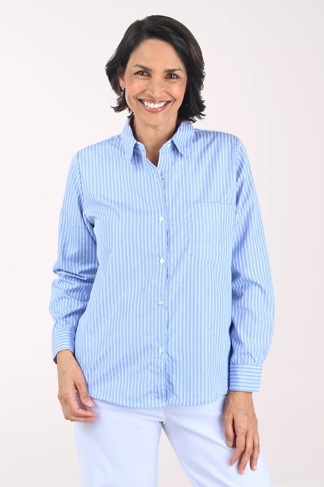 Woman wearing a blue striped shirt against a white background