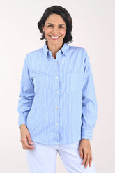 Woman wearing a blue striped shirt against a white background