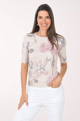 Woman wearing a floral patterned top on a white background