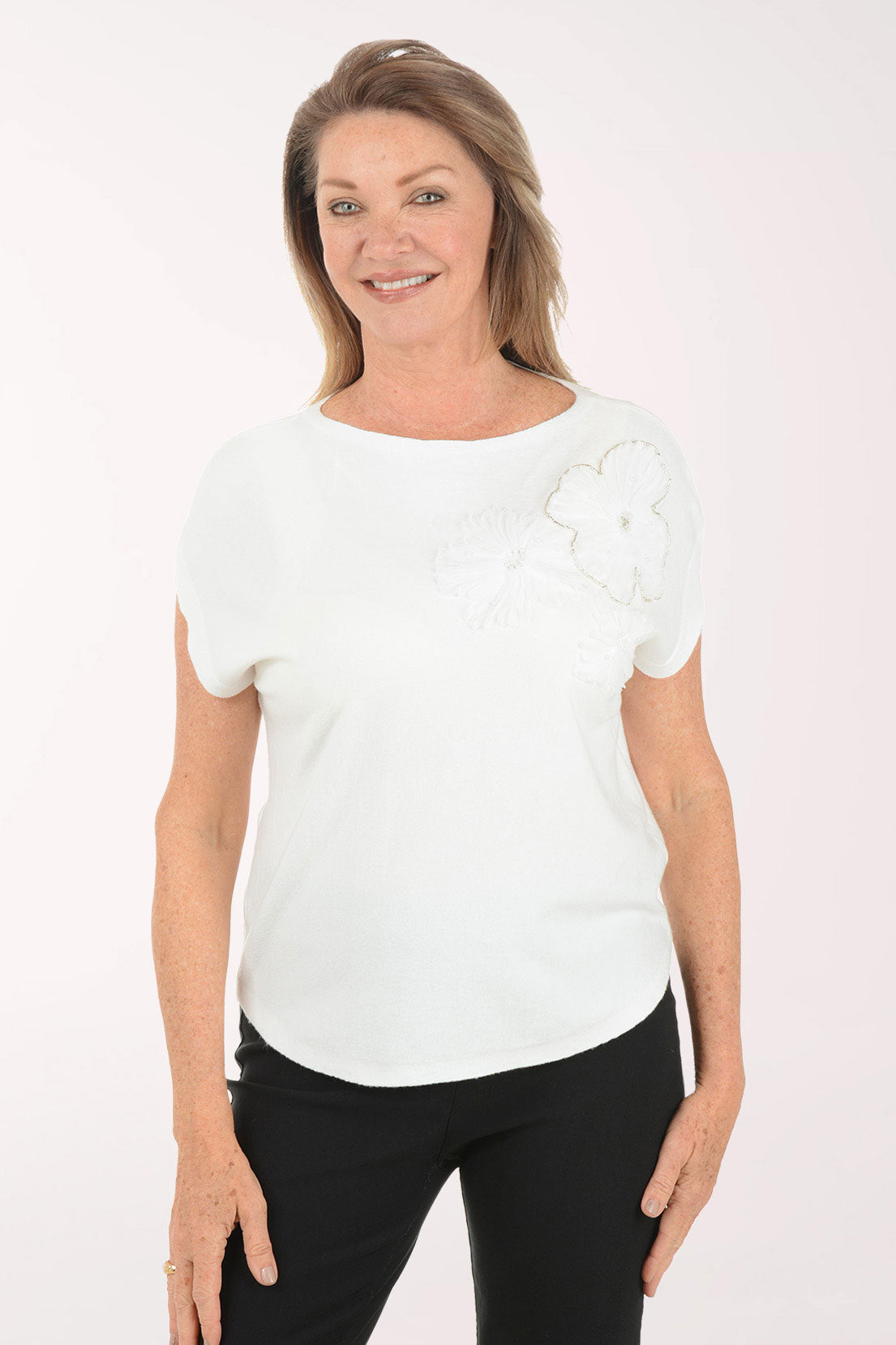 Woman wearing a white blouse with ruffled sleeves on a white background