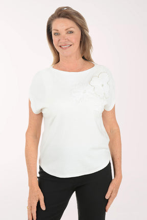 Woman wearing a white blouse with ruffled sleeves on a white background