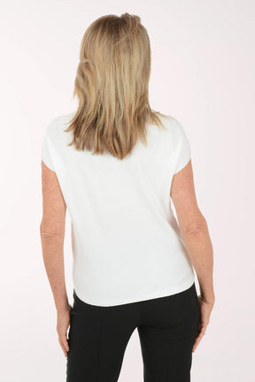 Woman wearing a white blouse with ruffled sleeves on a white background