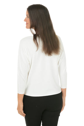 A woman wearing a white 3/4 sleeve sweater with a jeweled dragonfly detail. Back shot.