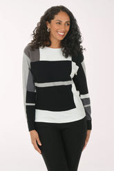 Woman wearing a black, white, and gray striped sweater on a white background