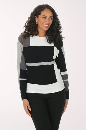 Woman wearing a black, white, and gray striped sweater on a white background