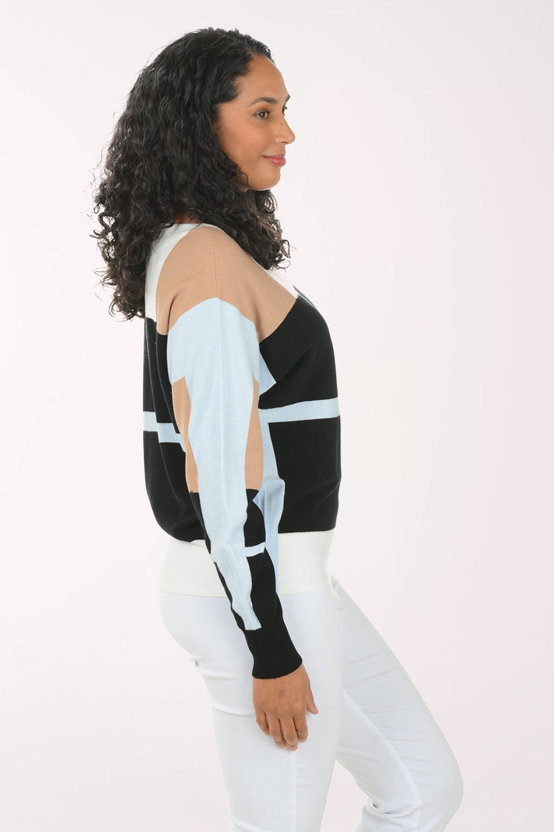 Woman wearing a black and white striped sweater with cut-out sleeves on a white background