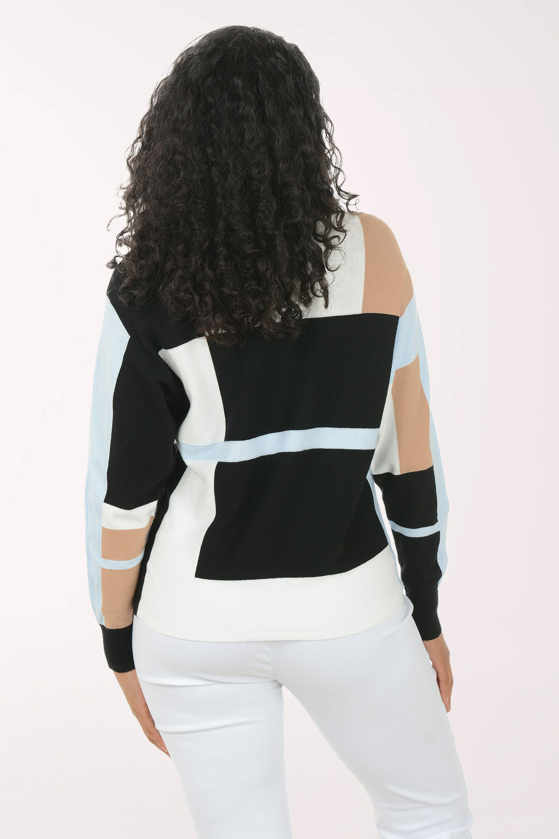 Woman wearing a black and white striped sweater with cut-out sleeves on a white background