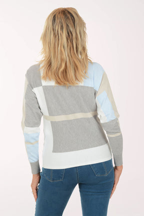 Person wearing a colorful sweater with a neutral background