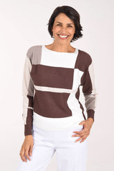 Woman wearing a long sleeve brown color block sweater