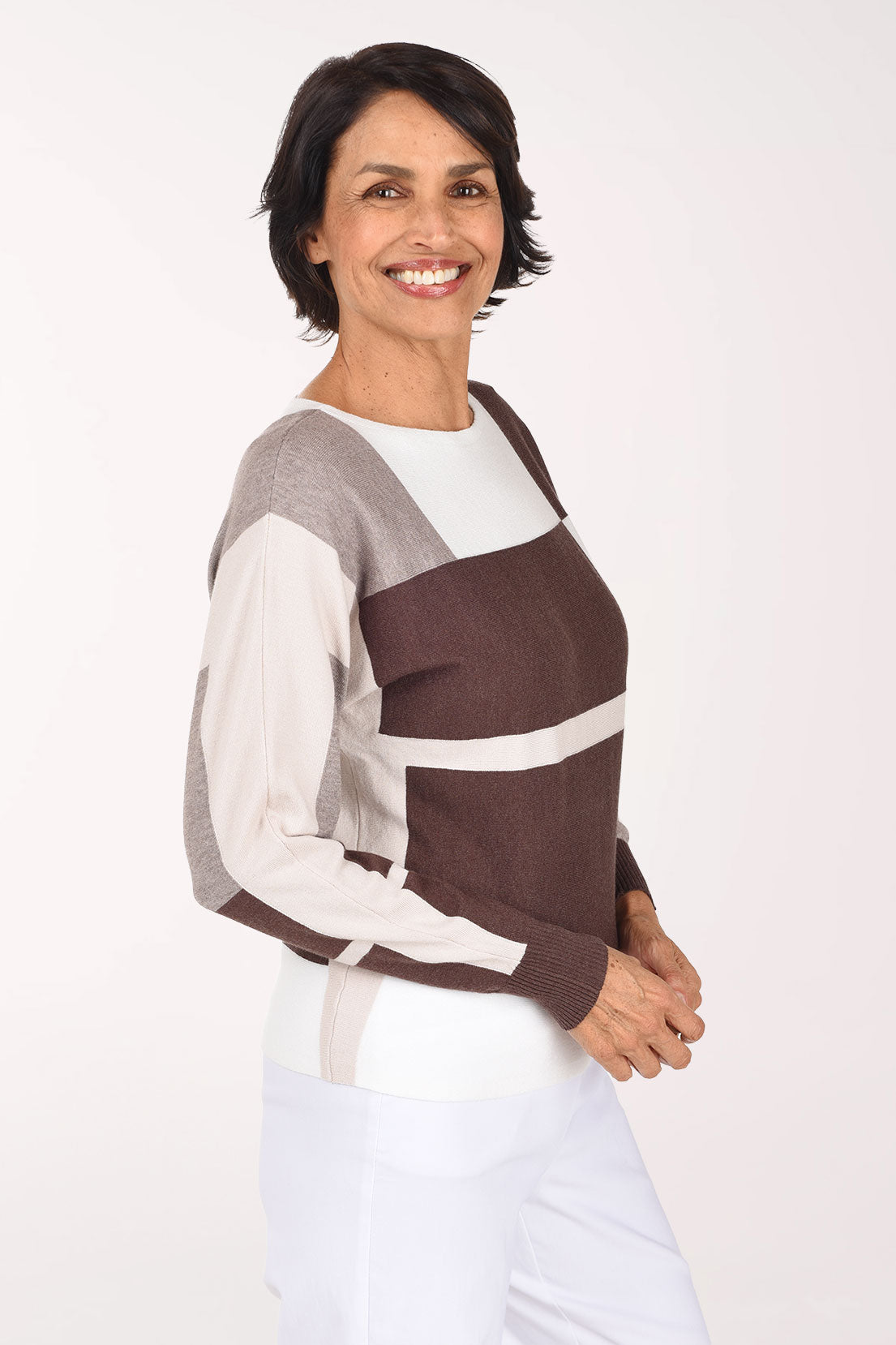 Woman wearing a long sleeve brown color block sweater