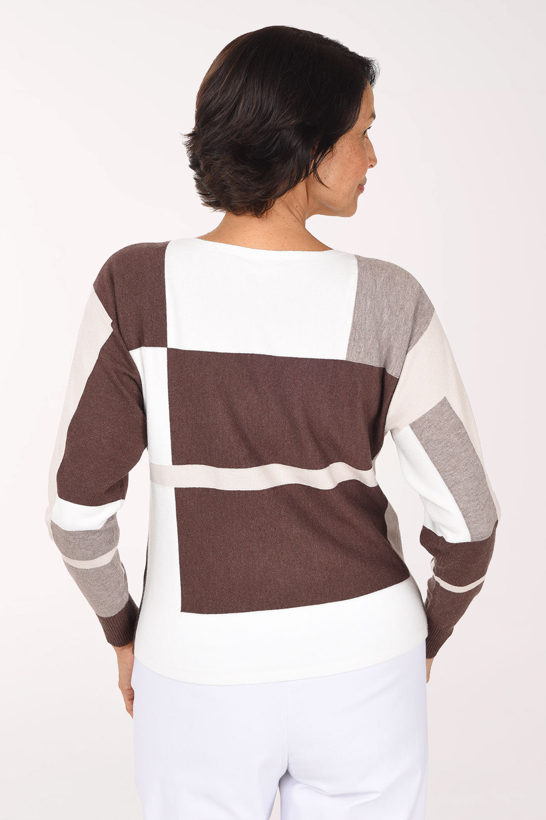 Woman wearing a long sleeve brown color block sweater