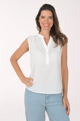 Woman wearing a white sleeveless collarless blouse