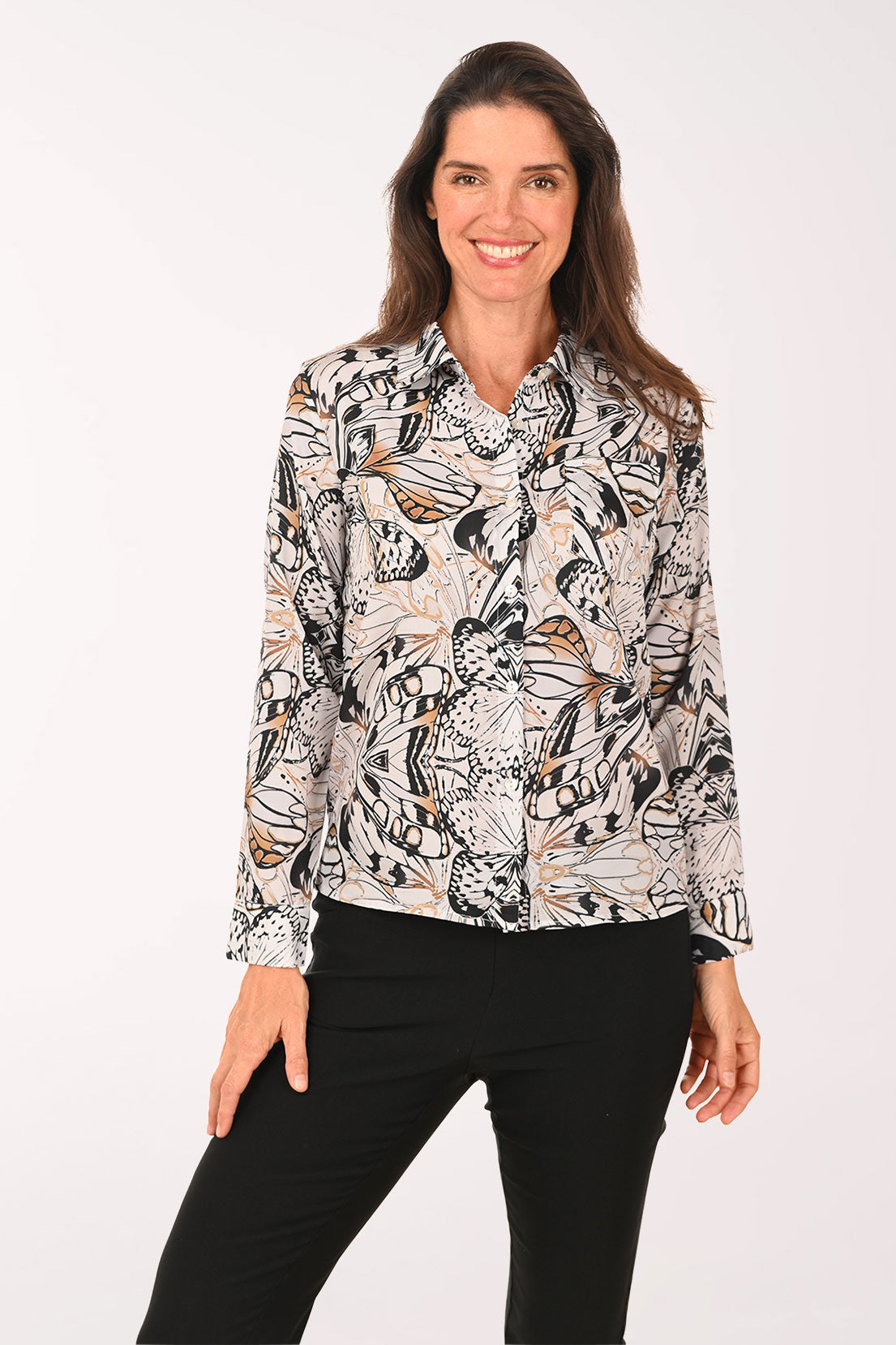Woman wearing a black long sleeve shirt with a butterfly print.