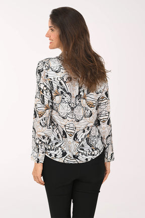 Woman wearing a black long sleeve shirt with a butterfly print.