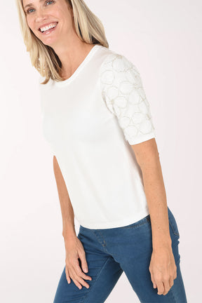 Woman wearing a white t-shirt and blue jeans on a white background