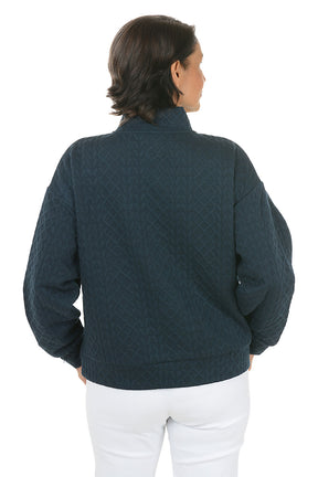 Woman wearing a dark blue pullover with a zipper on a white background. Back shot.