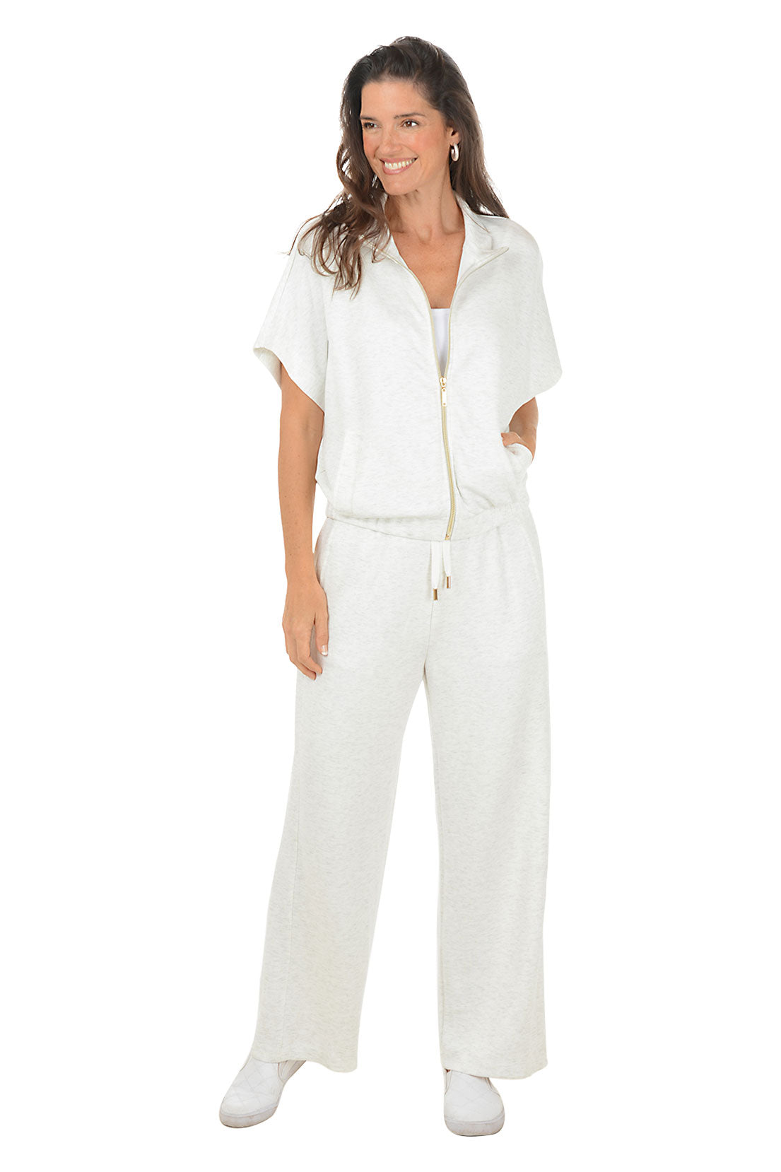 Woman wearing a white outfit with a gold zipper on a white background