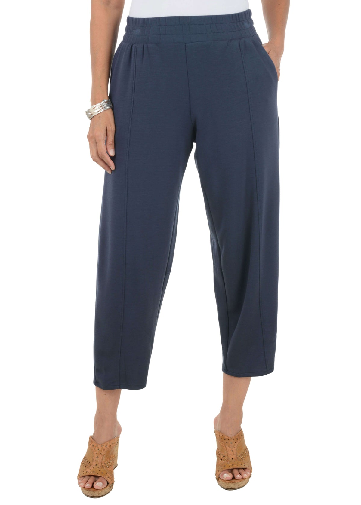 Navy blue pants worn by a person on a white background