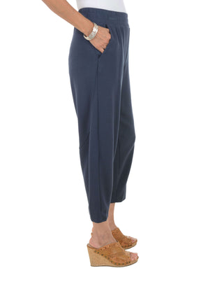 Navy blue pants worn by a person on a white background