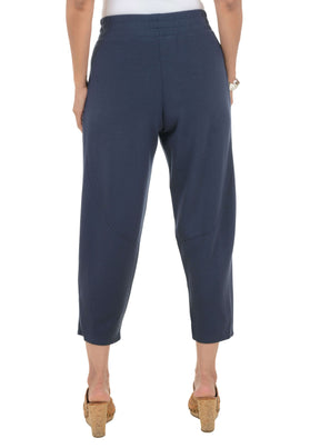 Navy blue pants worn by a person on a white background