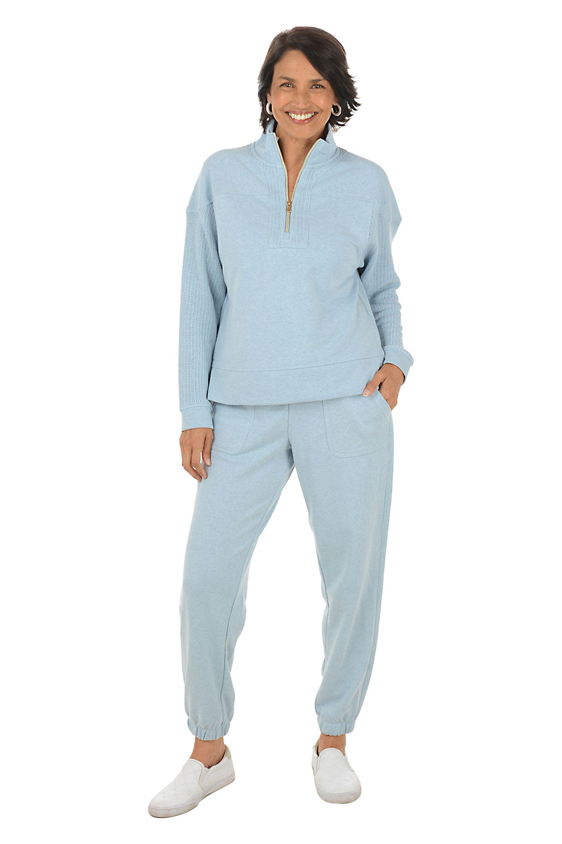 Woman wearing a light blue fleece outfit on a white background