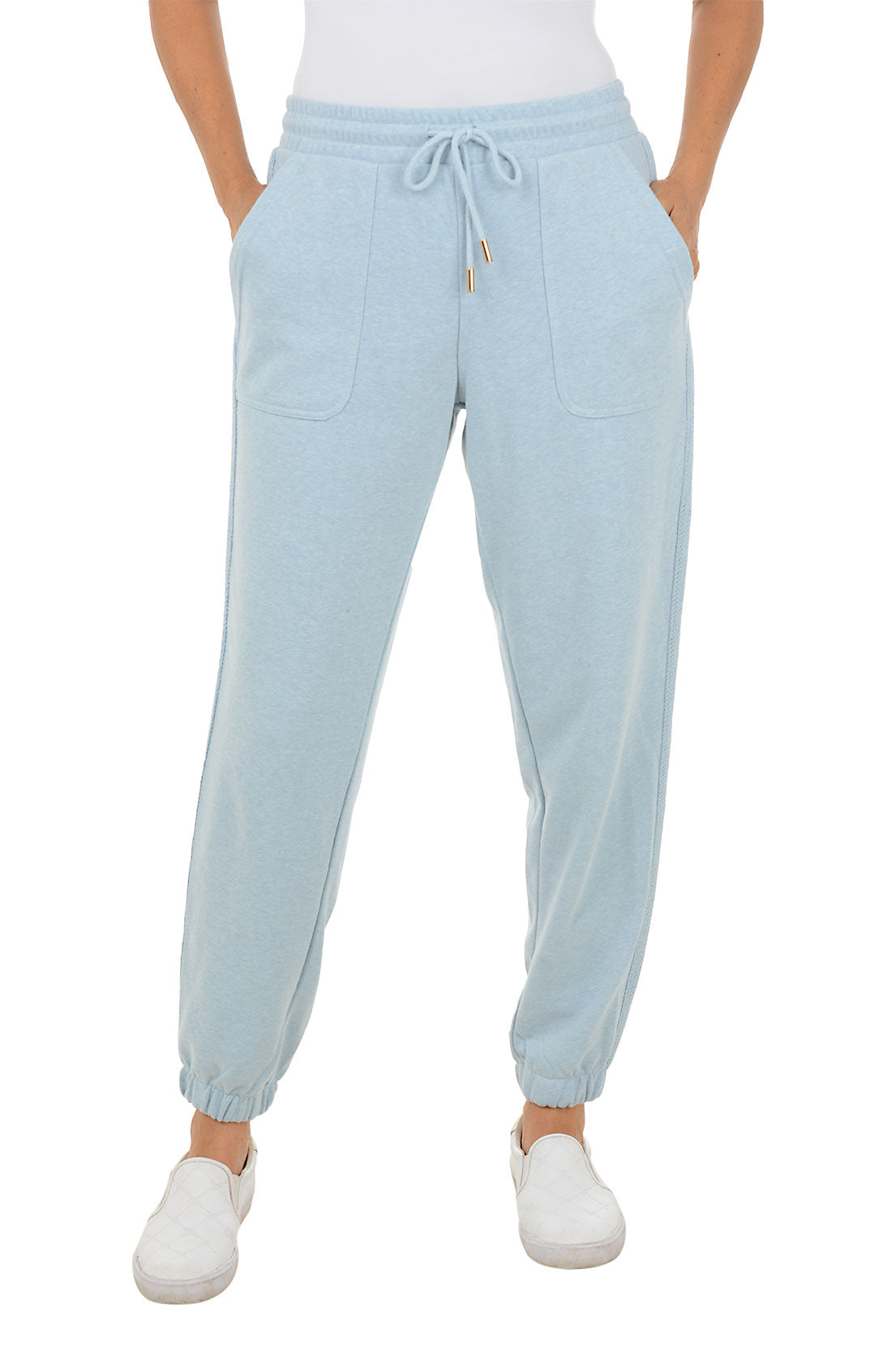 Light blue jogger pants worn by a person on a white background