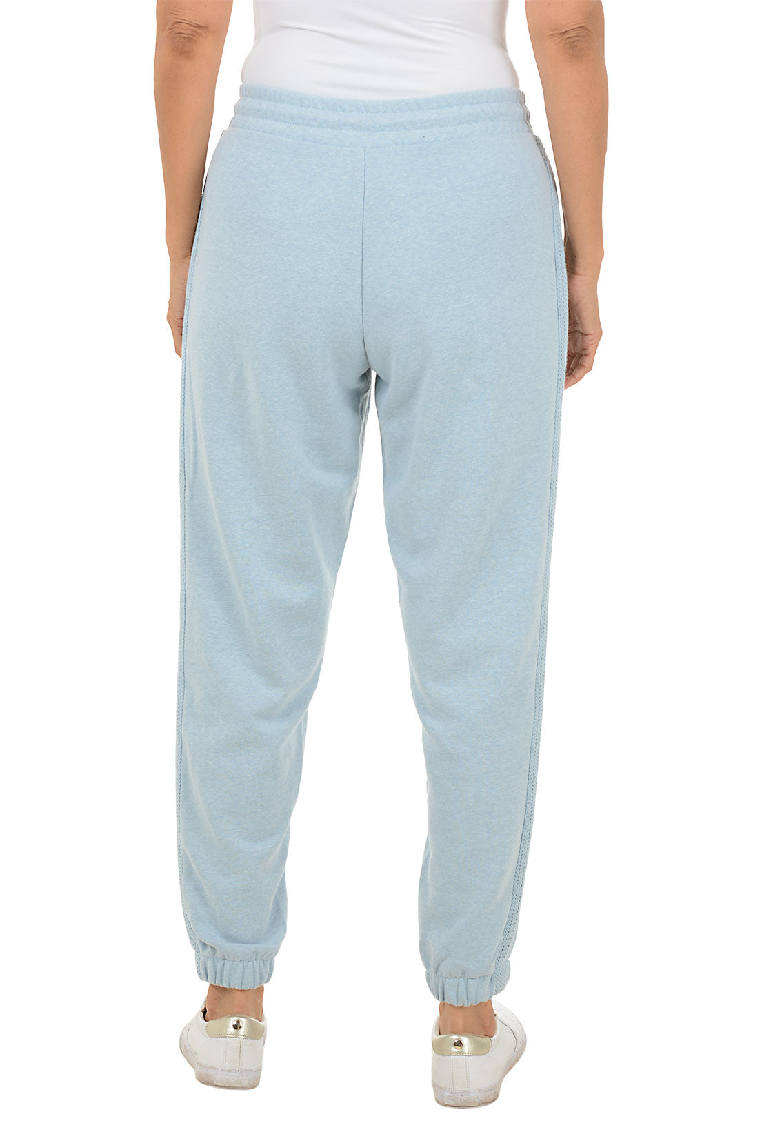 Light blue sweatpants worn by a person on a white background