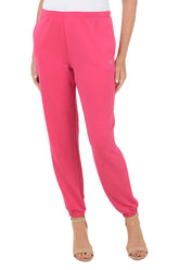Pink sweatpants worn by a person on a white background