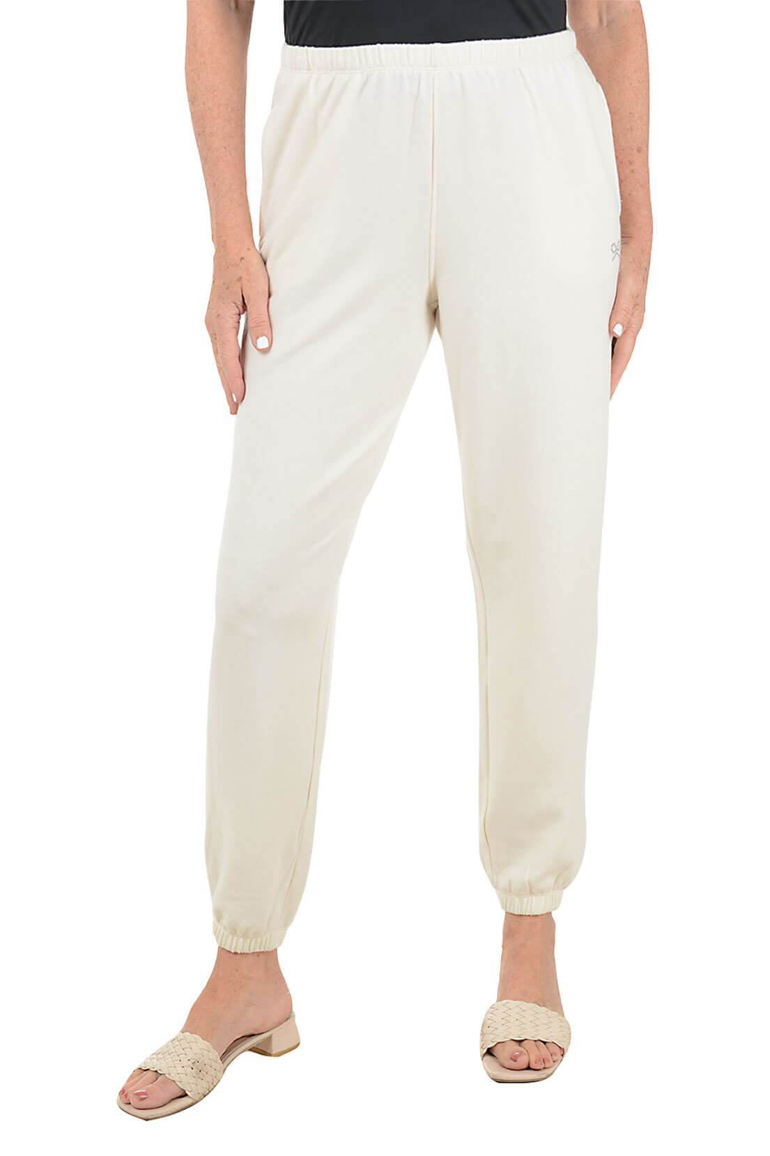 White pants worn by a person on a white background
