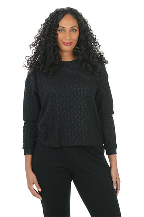 Woman wearing a black sweater and pants on a white background
