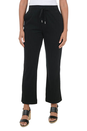 Black pants worn by a person on a white background