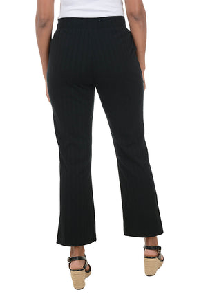 Black pants worn by a person on a white background